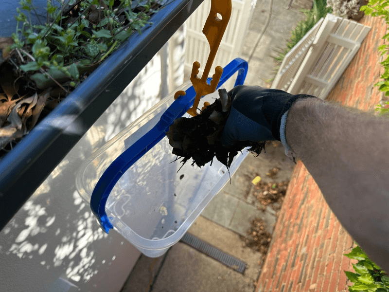 Drop gutter debris into the bucket